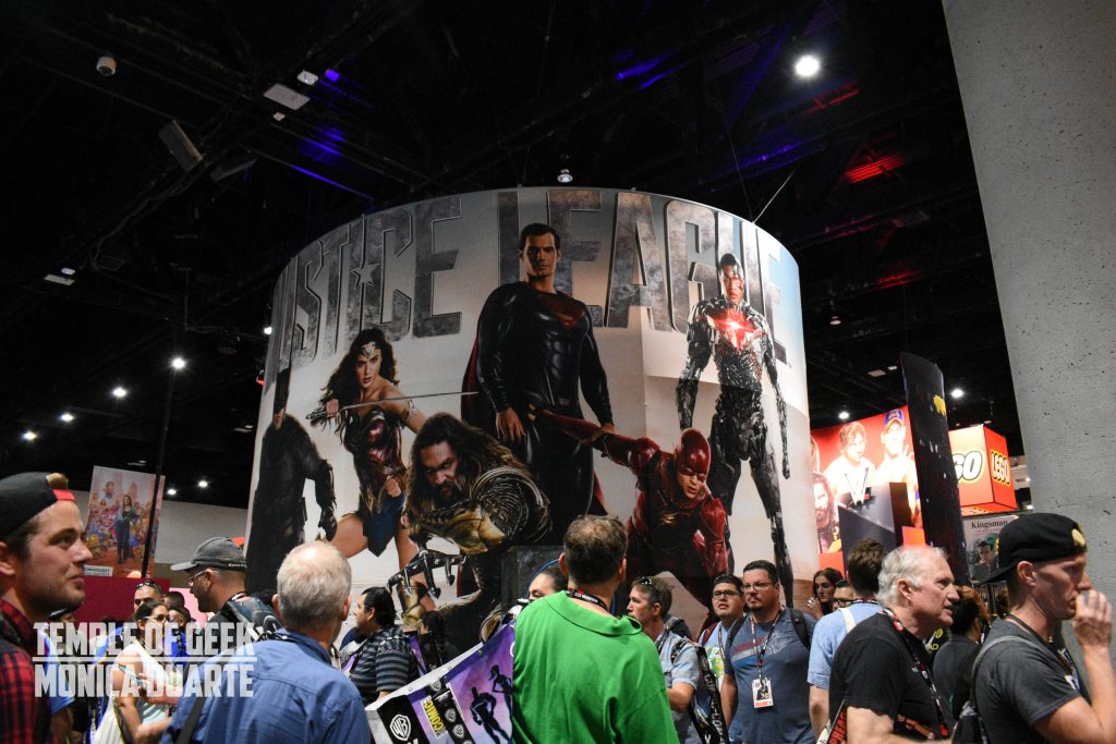 crowds of people walk through the exhibit hall at san diego comic con