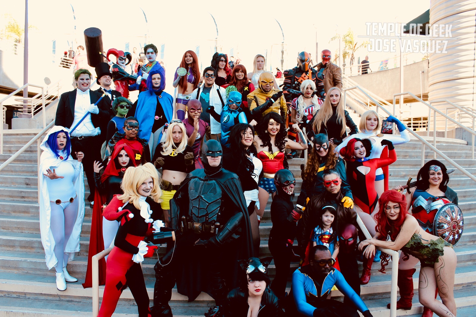 Group photo of the DC Comics Cosplay Meet up at Long Beach Comic Con 2018. Almost 40 cosplayers gather staggered at the stairway that is adjacent to the convention center. 