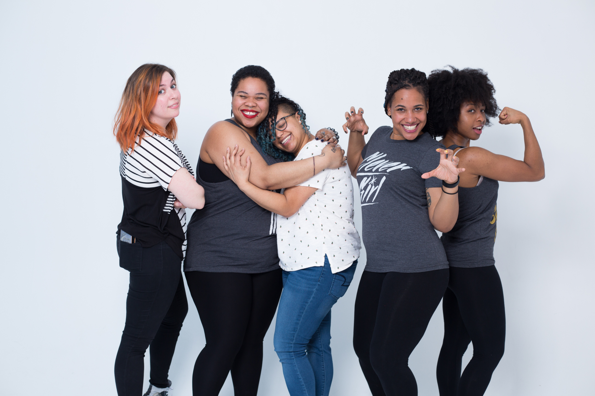 Jordan and four friends stand and embrace and hug one another during a photo shoot