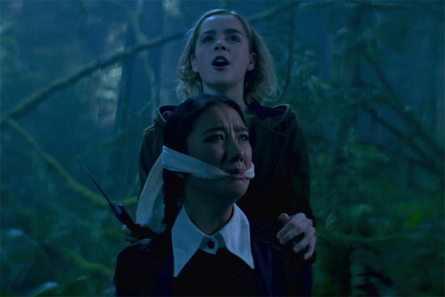 Sabrina Spellman has a knife in her hands and is about to sacrifice weird sister Agatha