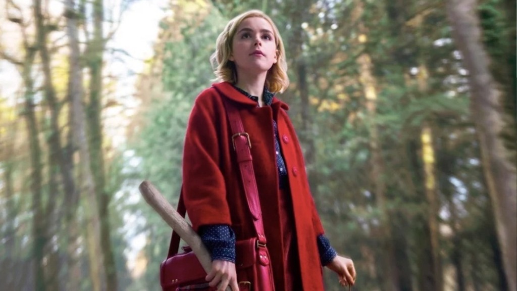 sabrina spellman in the woods with her red coat