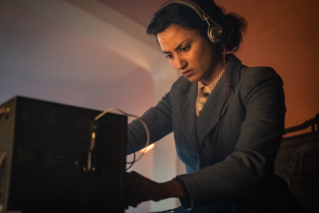 Paris in the 2nd World War. A woman is using a telegraph machine. Auror Marion as Noor Inayat Khan - Doctor Who _ Season 12, Episode 2 - Photo Credit: James Pardon/BBC Studios/BBC America