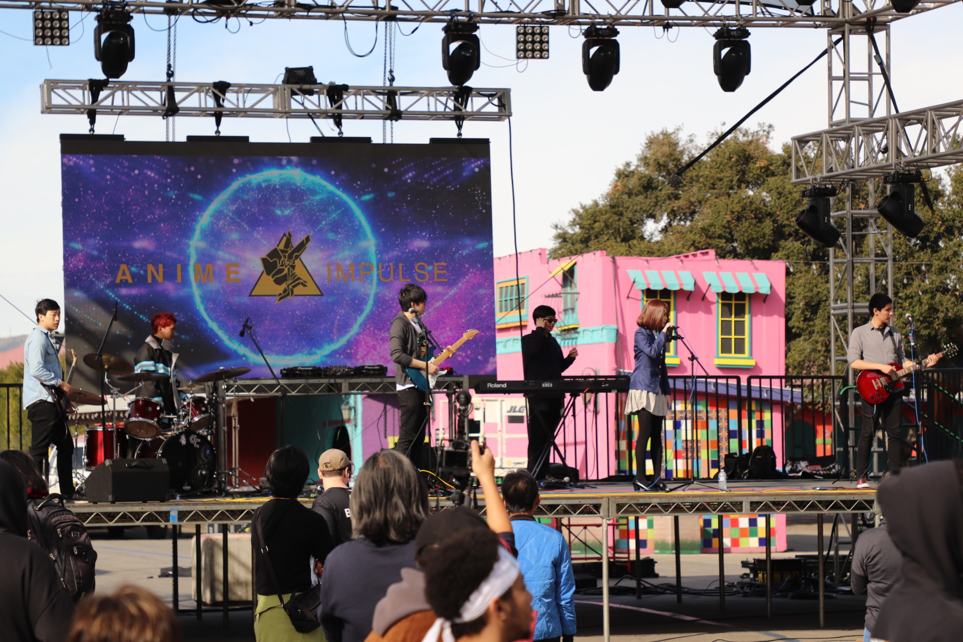 A band prepares to perform on a stage