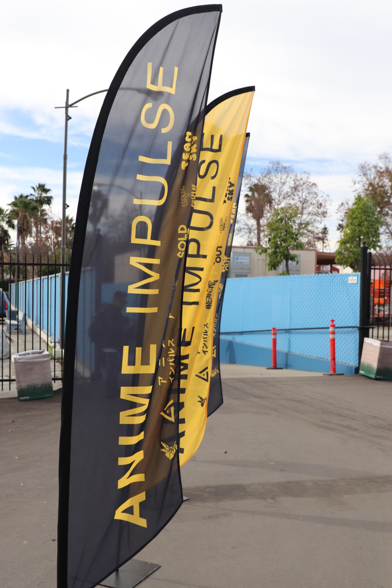 Stand alone flags outside of the event enterance. They say ANIME Impulse