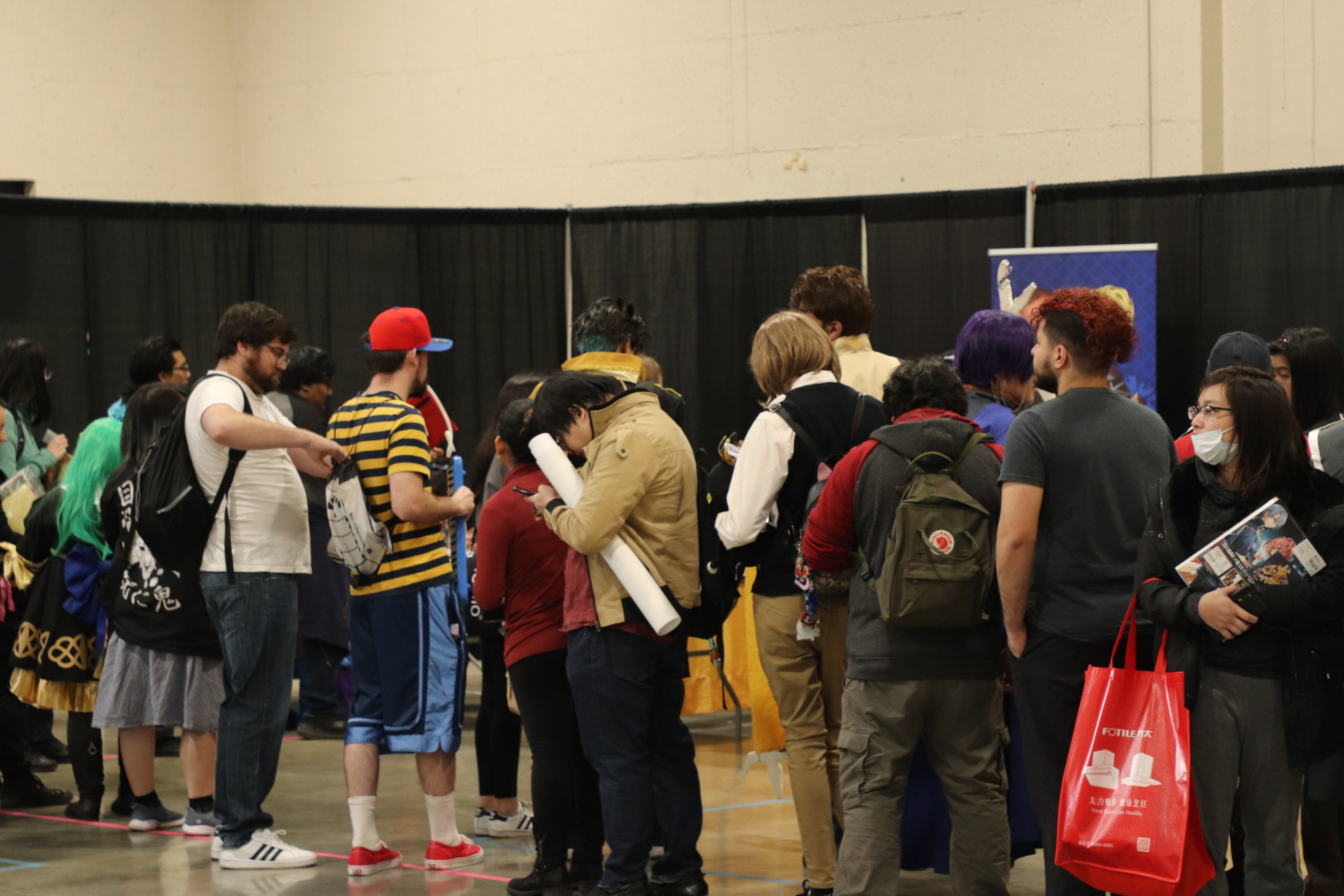 Group of people lined up in the exhibit hall.