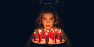 chilsabrina spellman on her birthday sitting in front of her birthdaycake with candlesling-adventures-of-sabrina-poster-trailer-tomorrow-3on9yi528b