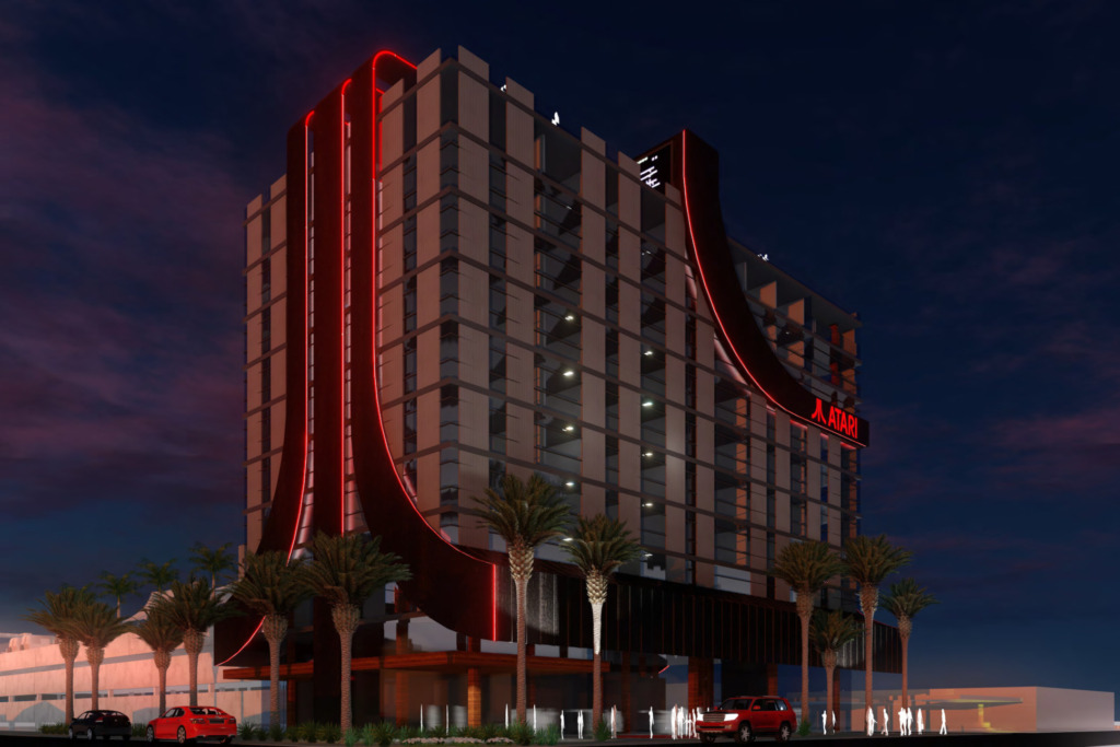 concept art of the new Atari Hotel. Image of a hotel at night. the building has part of the red artari logo built into the design. 