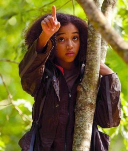 Scene from the film 'The Hunger Games'. The character Rue who is Portrayed by Amandla Stenberg is in a tree pointing out a nest