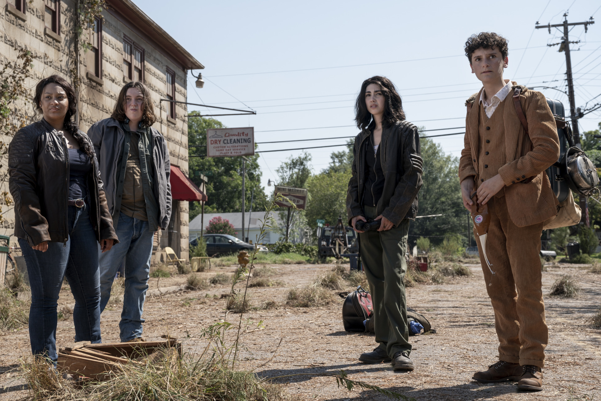 Alexa Mansour as Hope, Aliyah Royale as Iris, Hal Cumpston as Silas, Nicolas Cantu as Elton stand outside a desolated post-apocalyptic shopping center. Looking back as they are carrying backpacks and traveling through the town.