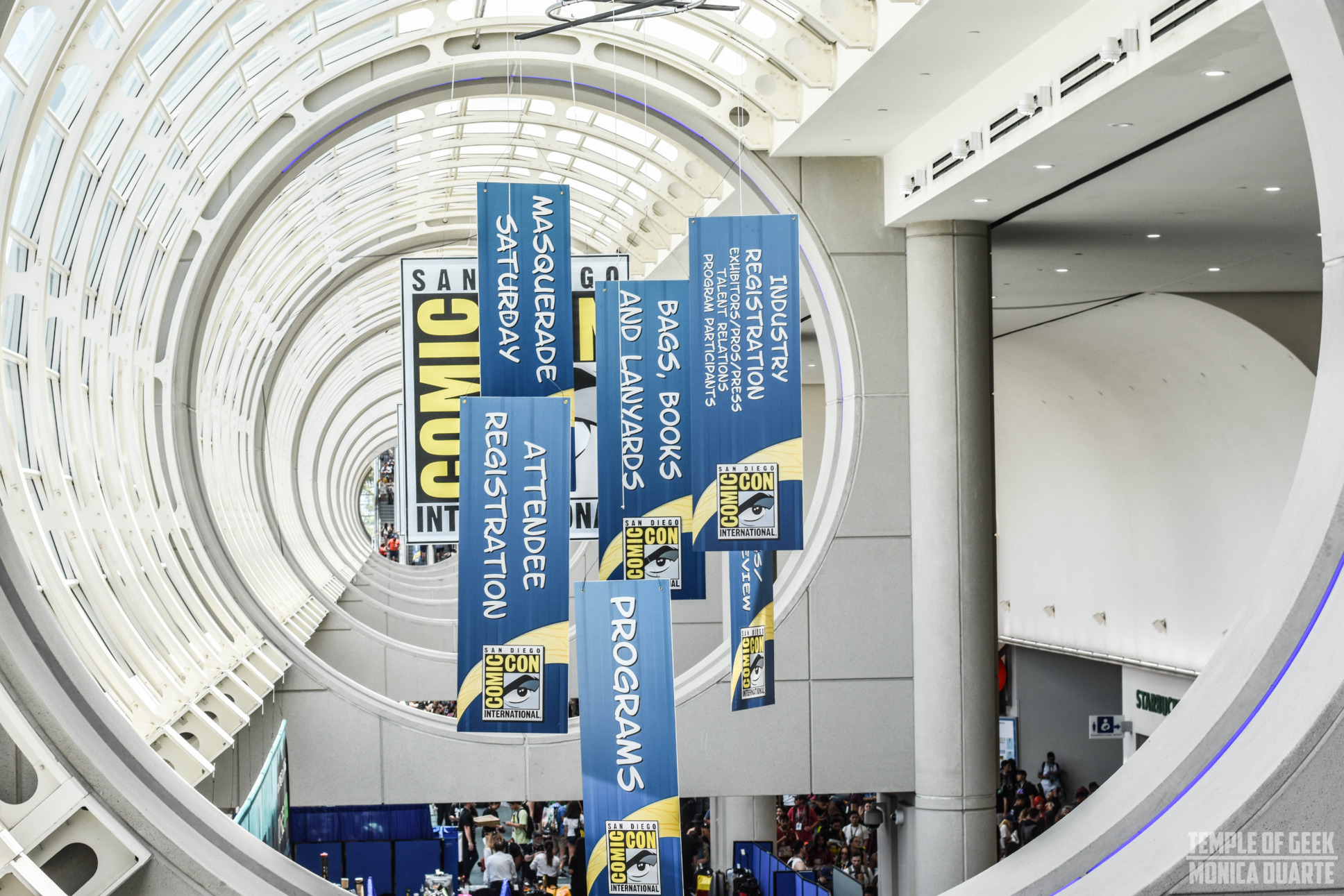 Comic-Con Banners hanging inside the San Diego Convention Center in 2018, view is from the second floor and attendees are seen walking below on the first floor