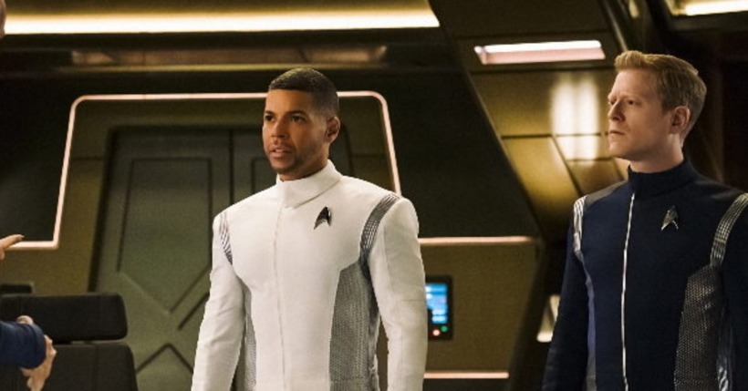 Standing on the bridge of the discover in their star fleet uniforms Wilson Cruz as Doctor Hugh Culber and Anthony Rapp as Lt. Commander Paul Stamets in 'Star Trek: Discovery' 