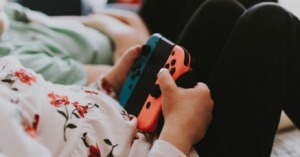 A child's hands are holding a Nintendo Switch 