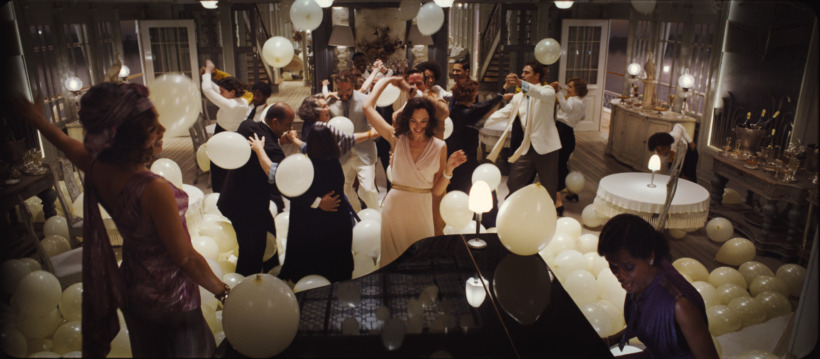 Gal Gadot dancers in the center of a party. Death on the Nile trailer still from 20th century studios