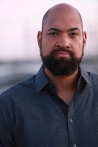 Headshot of B. Dave Walters. He is standing outdoors. the background is blurred out and not visible. He is wearing a dark colored button down shirt.