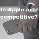 Photo of an iphone 11 being held in someones hand. It is a closeup of the phone. Written over the images are the words "Is Apple anti-competitive?"