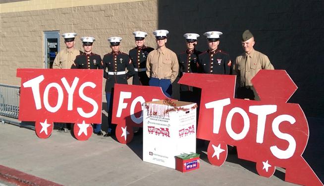 United States Marines in their dress blue uniforms stand outside the entrance of Walmart in December 2015.