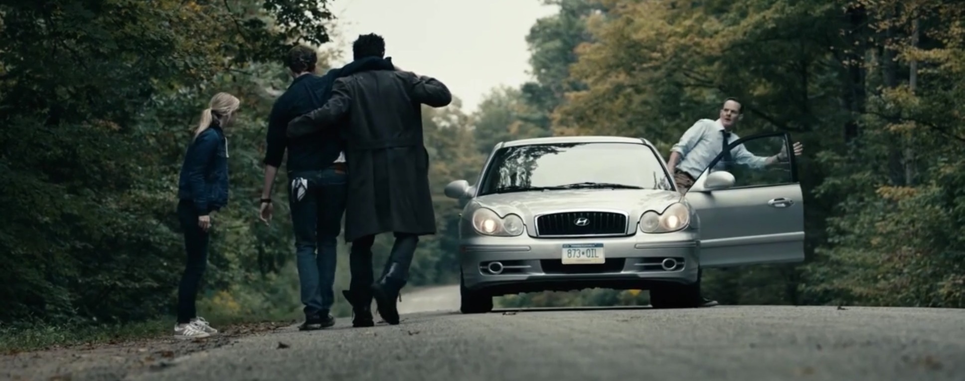 Scene from the Boys with Annie and Butcher holding Hughie, stopping a car