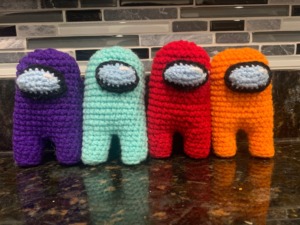 Among Us crotched characters from Etsy in purple, cyan, red, and orange