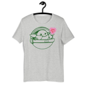 Baby Yoda holding a pink candy heart as a shirt from Friday Apparel for Galentine's Day