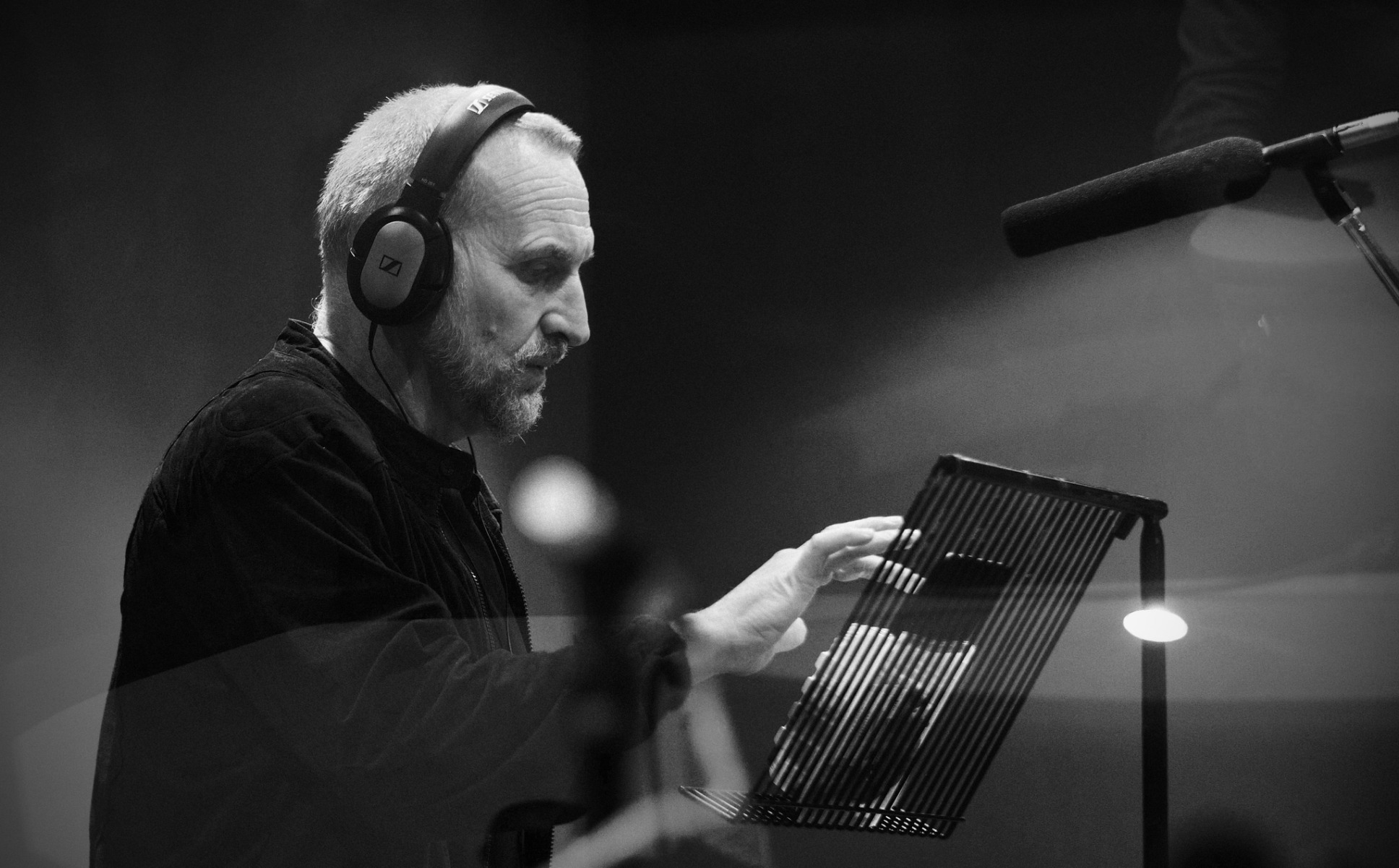 a black and white picture of Christopher Eccleston recording for The Ninth Doctor Adventures