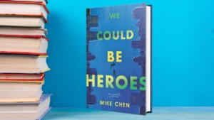 Mike Chen's book "We could be heroes" sits on a counter next to a stack of random books