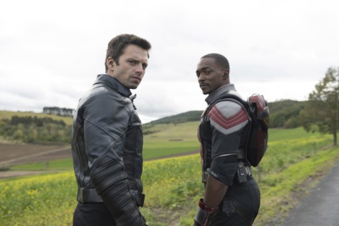 sebastian stan and anthony mackie in costume in a field of grass in the falcon and the winter soldier episode two