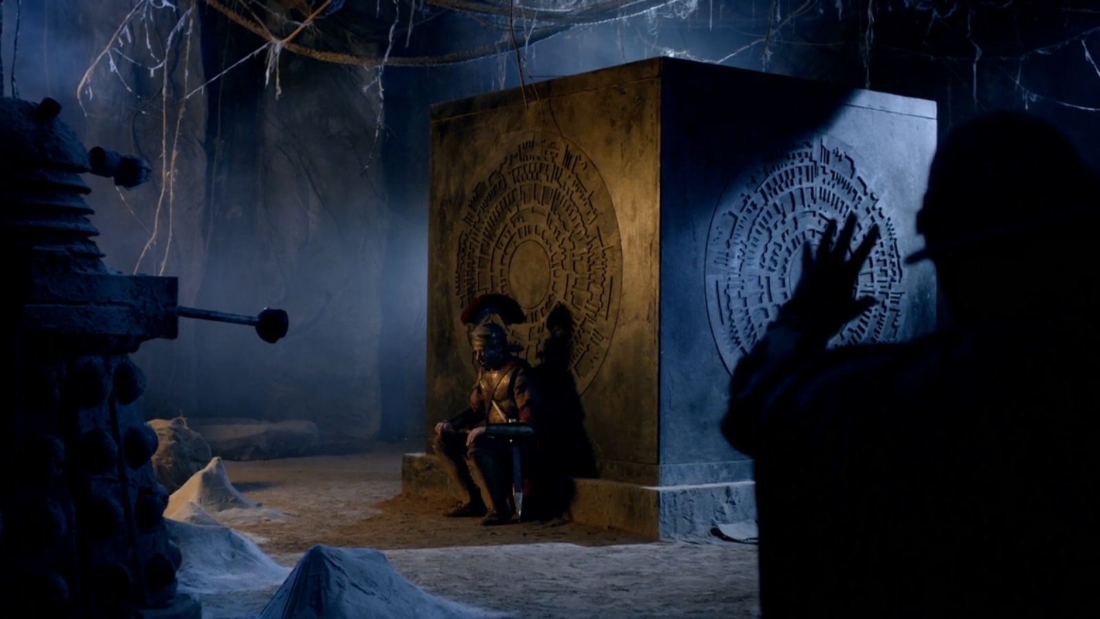 Rory sits by the side of the Pandorica that Amy is in, dressed in full Centurion gear