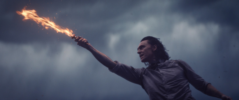 Loki (Tom Hiddleston) hold a flaming sword