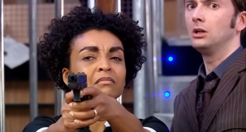 Francine Jones points a gun at the Master after a year of witnessing horrors as the Doctor approaches from behind