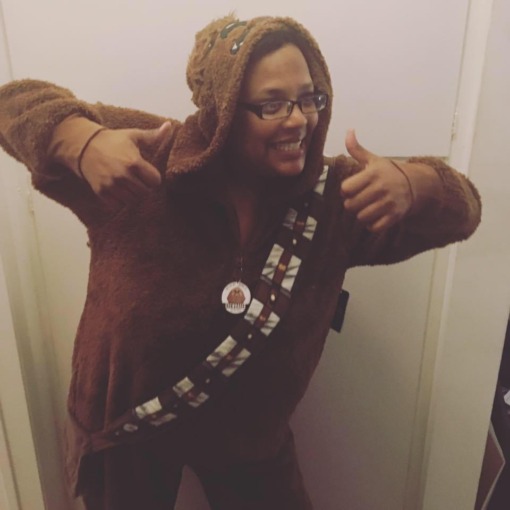 Klee Wiggins gives two thumbs up while wearing a Chewbaca inspired onsie