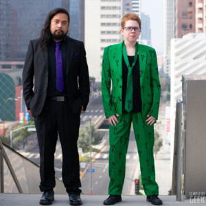 Two people model Joker and Riddler themed suits from Fun.com's DC Comics line. 