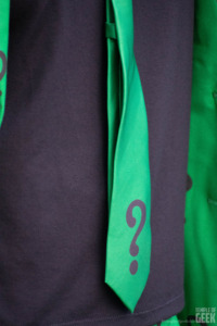 A closeup of a skinny tie with a question mark with a DC Comics Riddler suit from Fun.com. 