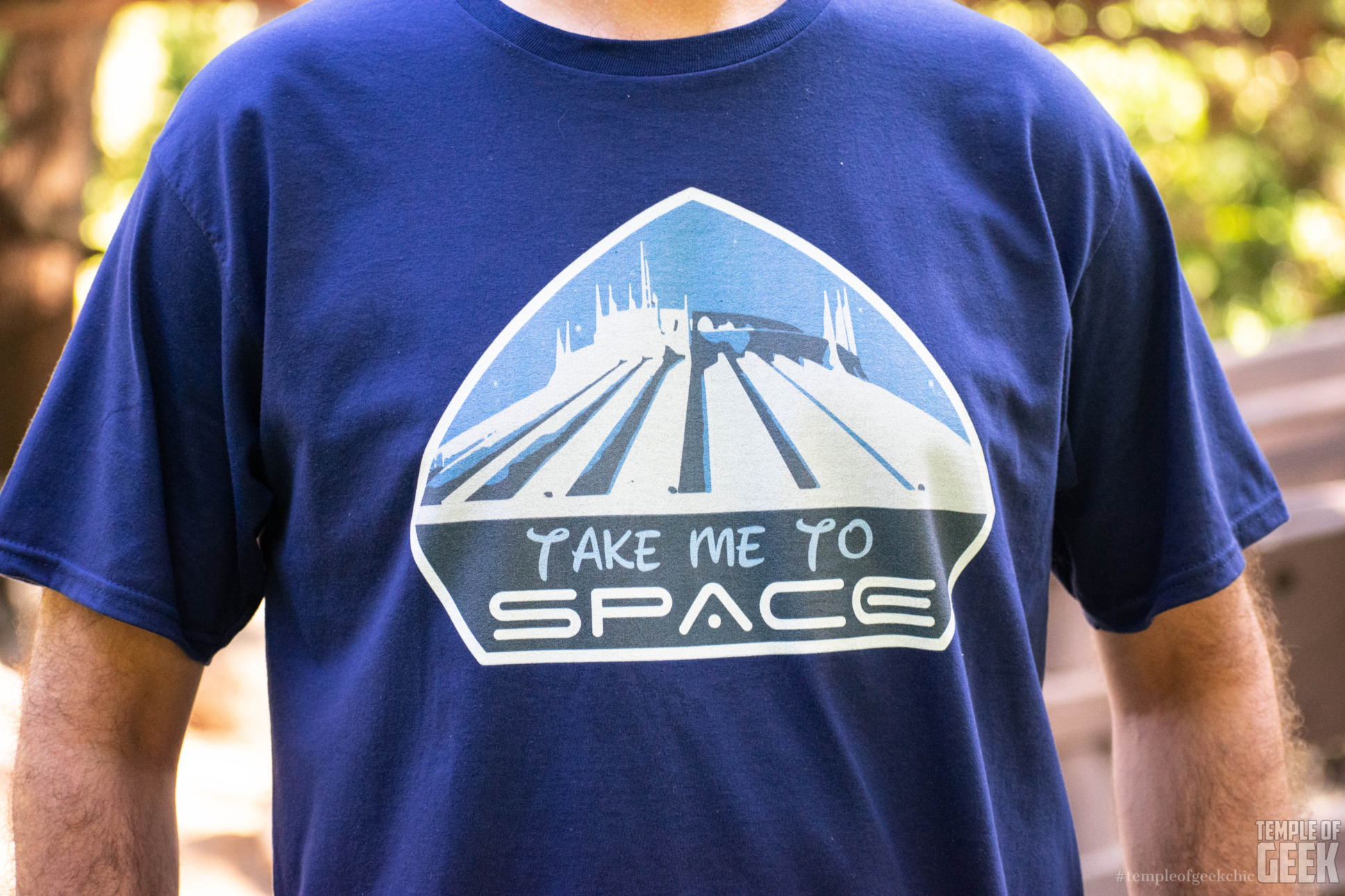 A closeup of a Disney-themed tee that reads "Take Me to Space."