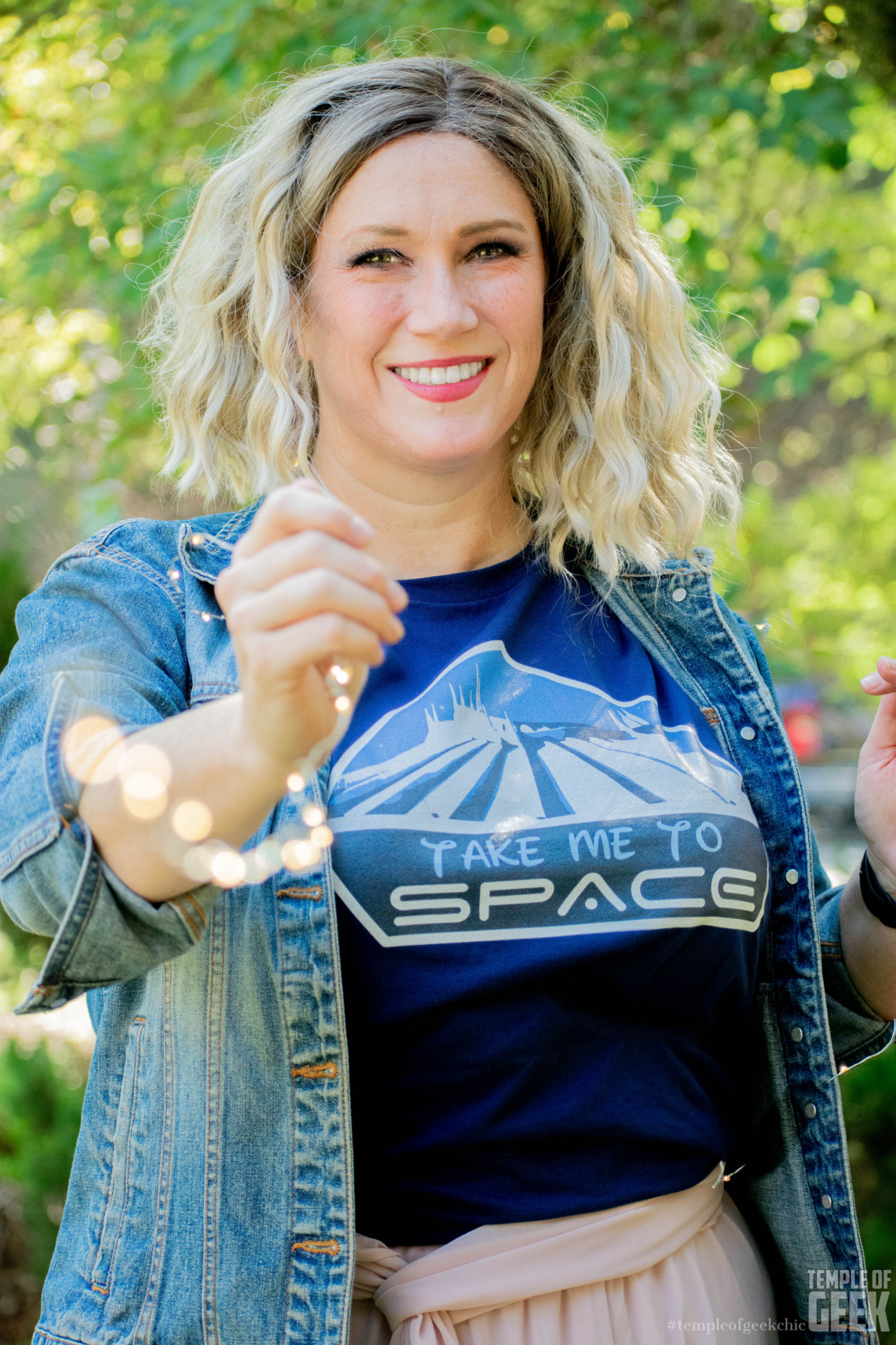 A model wears a Disney-themed tee with a Space Mountain logo that says "Take Me to Space."