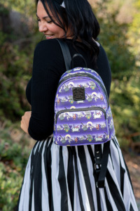 A model wears the Loungefly Nightmare Before Christmas backpack. 