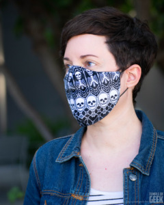 A model wears a face mask with a skeleton pattern from Fun.com.