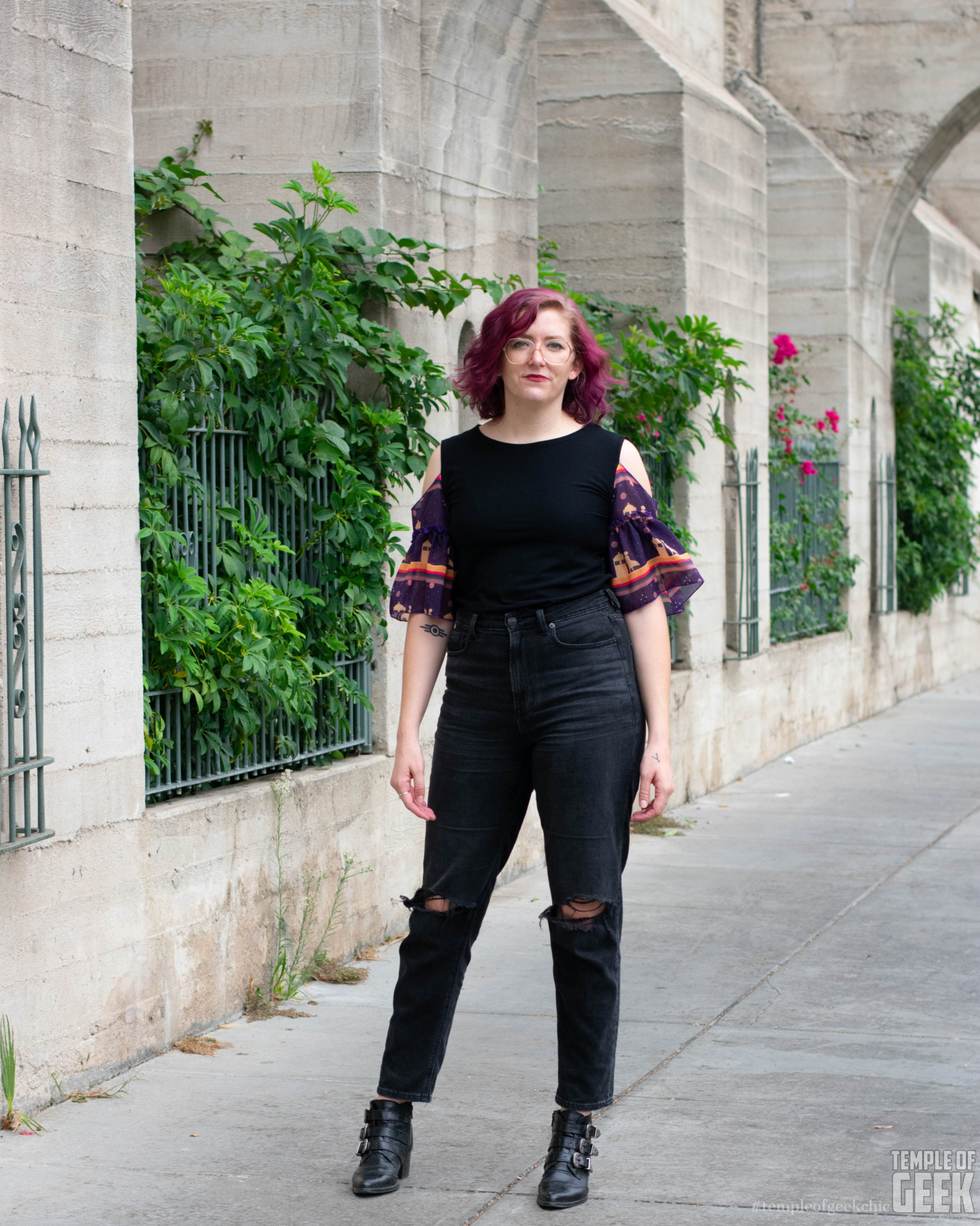 A model wears the ruffle sleeve top with a Doctor Who themed print from Heroicouture.