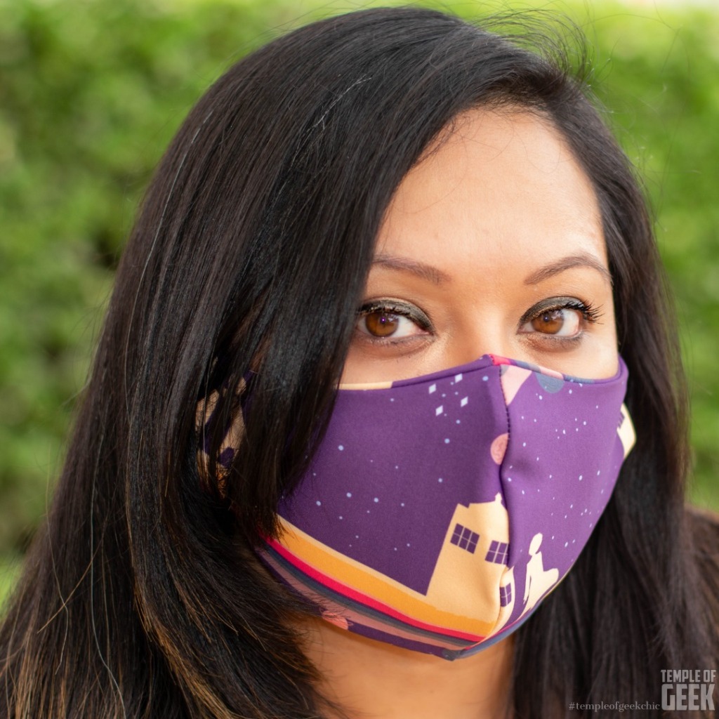 Closeup of a model wearing a Doctor Who themed face mask from Heroicouture.