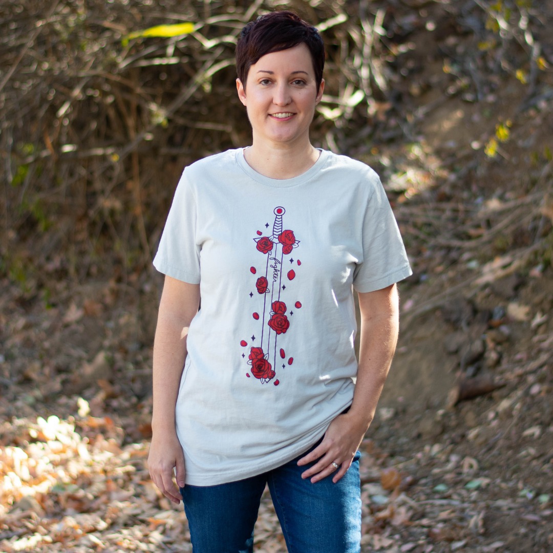 A model wears a tee featuring a sword covered in red flowers by D%D fashion brand Guild Party.