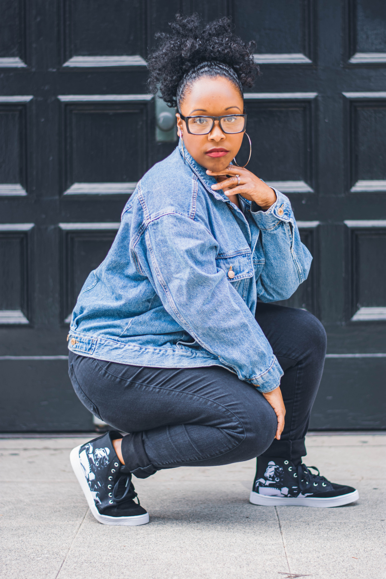 A model crouches to show off her Star Wars style high top sneakers.