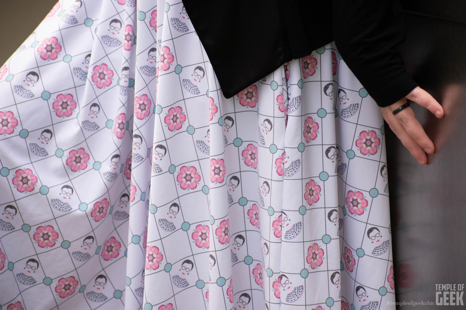 A closeup of a skirt by Heroicouture with a print featuring the likeness of Ruth Bader Ginsburg and other homages to the Supreme Court Justice.