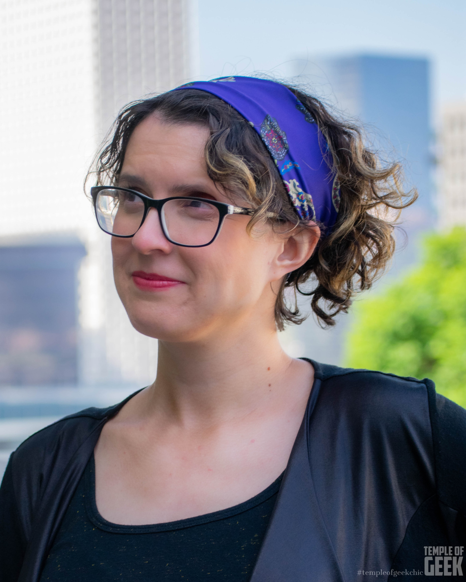 A model smiles. Her hair is held back by a Star Wars-themed headband.