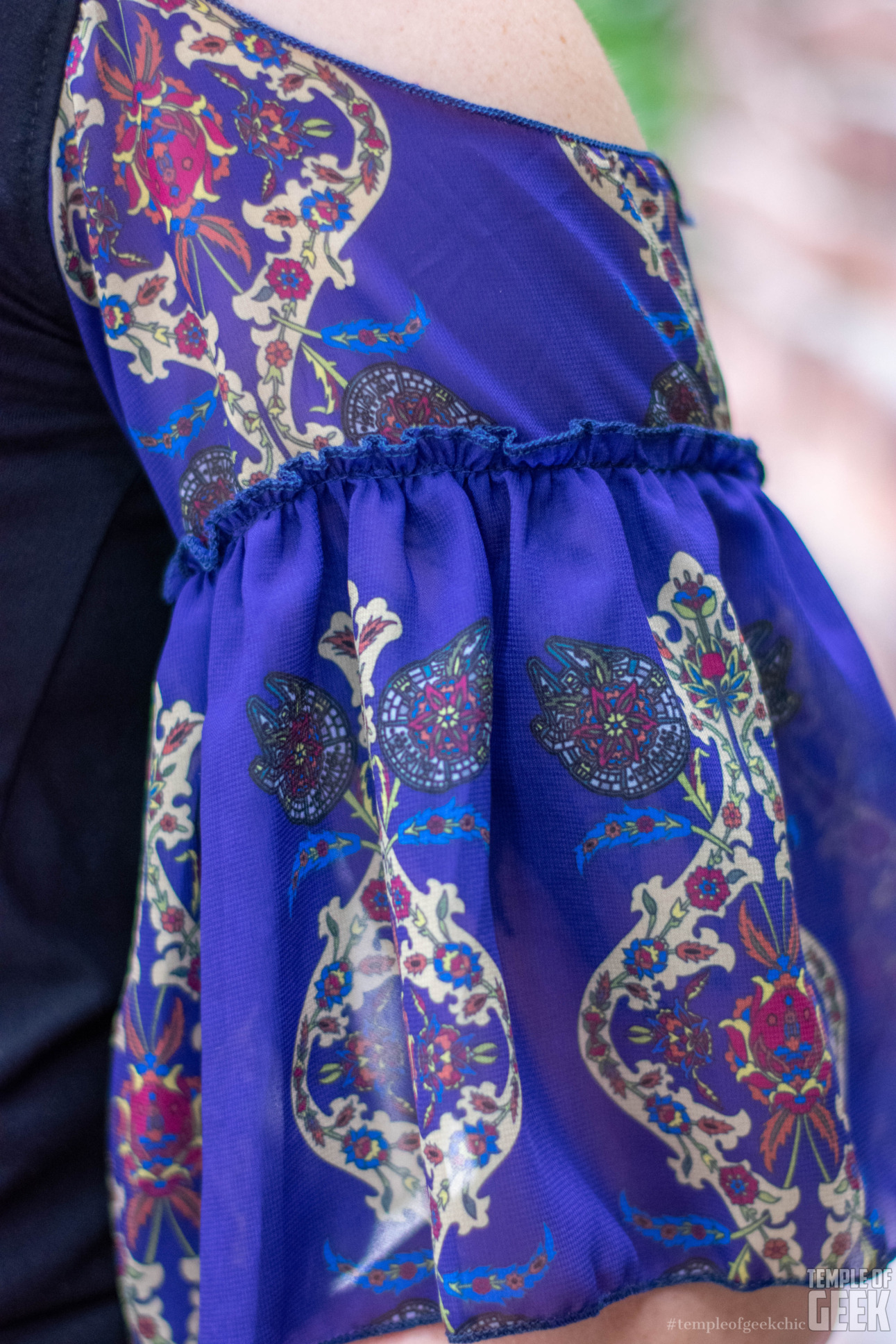 Closeup of a Millennium Falcon floral print on a ruffled sleeve by Heroiocouture.