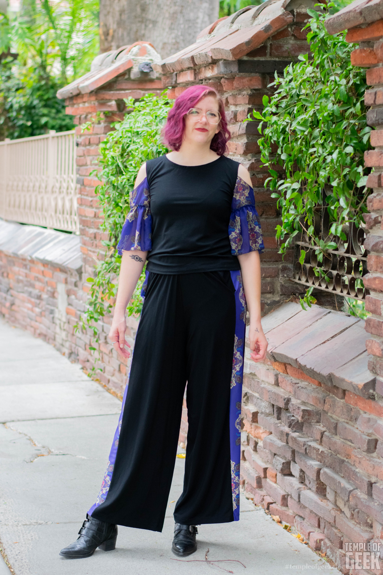 A model wears a tie sleeve top and palazzo pants with a Millennium Falcon print.