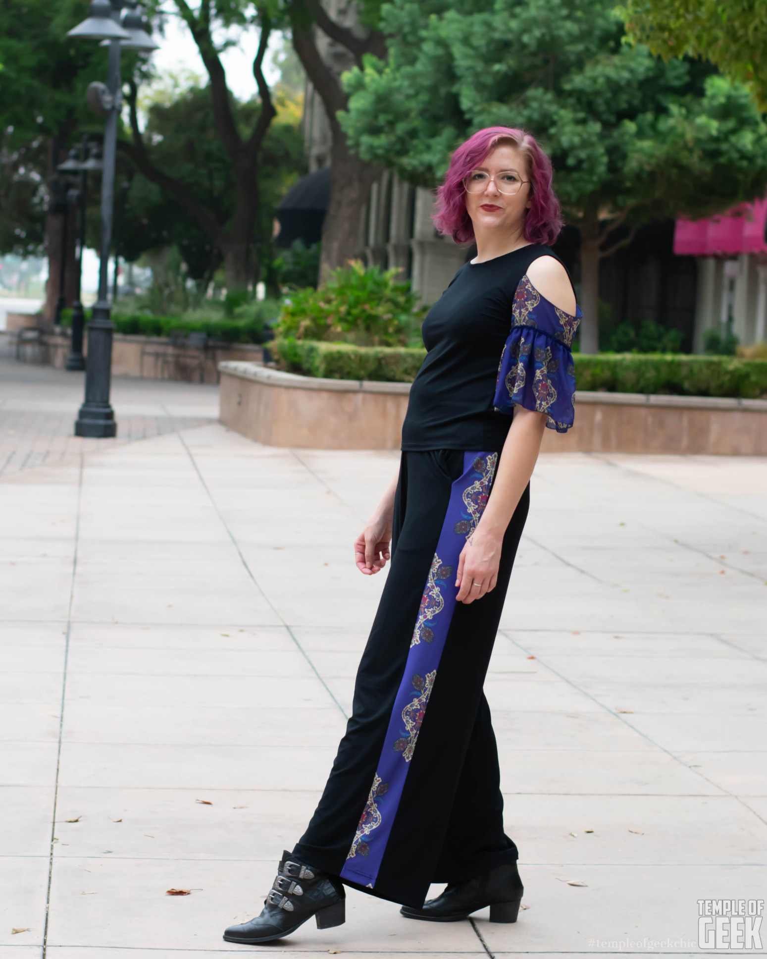 A model wears a ruffle sleeve top and palazzo pants by fashion brand Heroicouture.