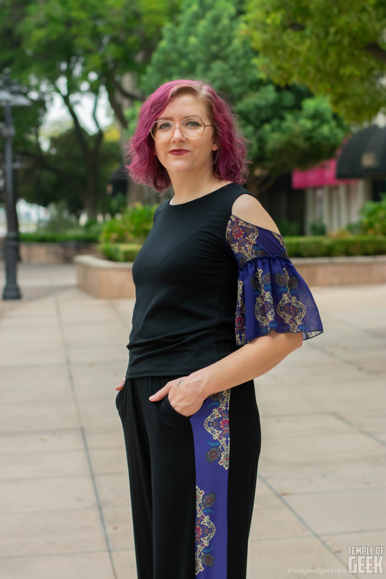 A closer view of a model wearing a ruffle sleeve top and palazzo pants.