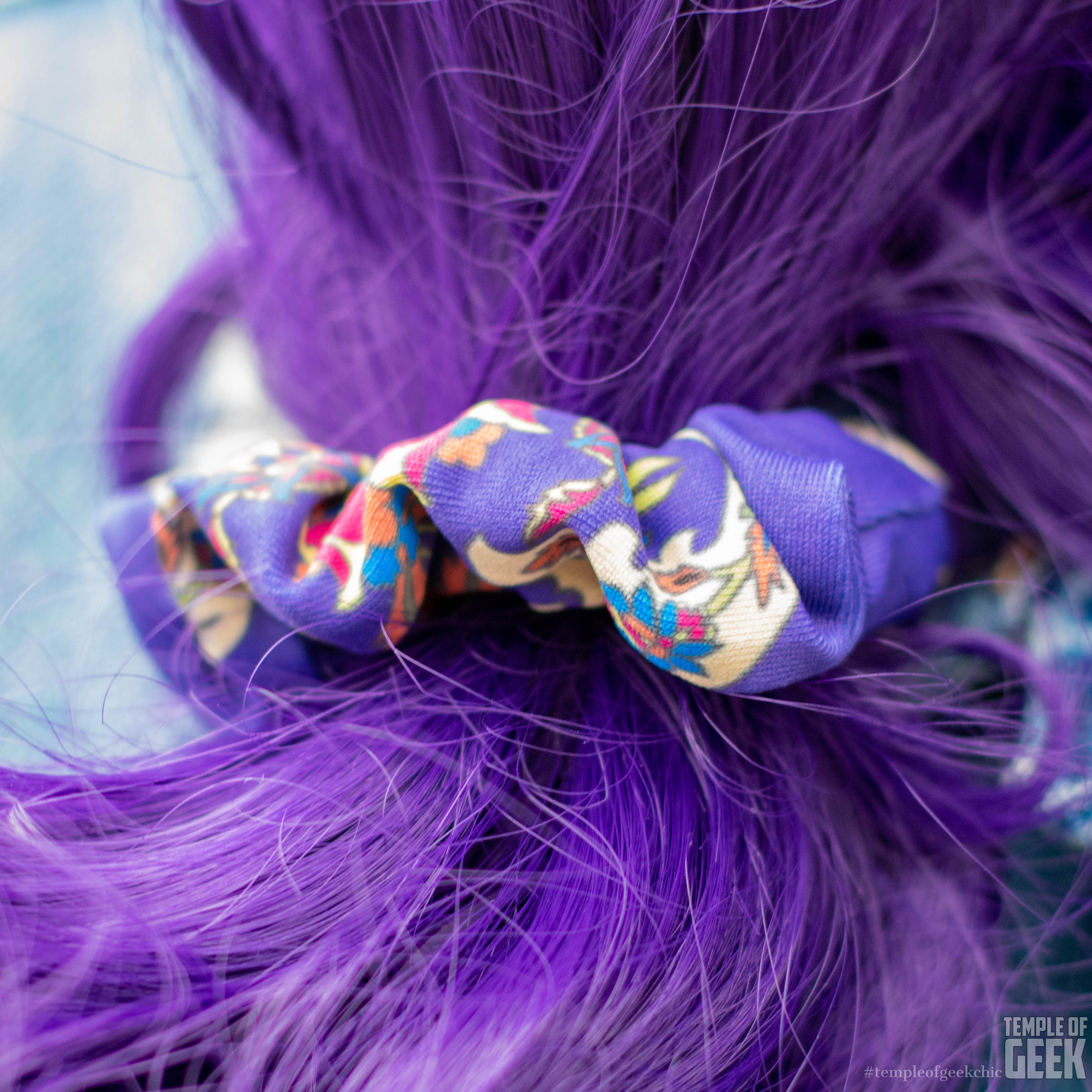 Closeup of a scrunchie and a purple-haired pony tail.