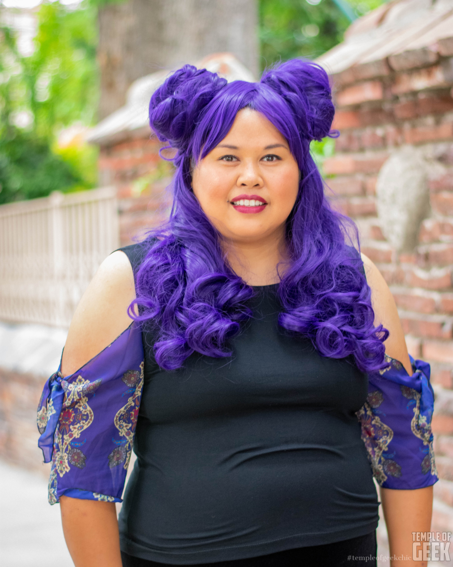 A model wears a purple wig and a tie sleeve top featuring tiny Millennium Falcons by Heroicouture.