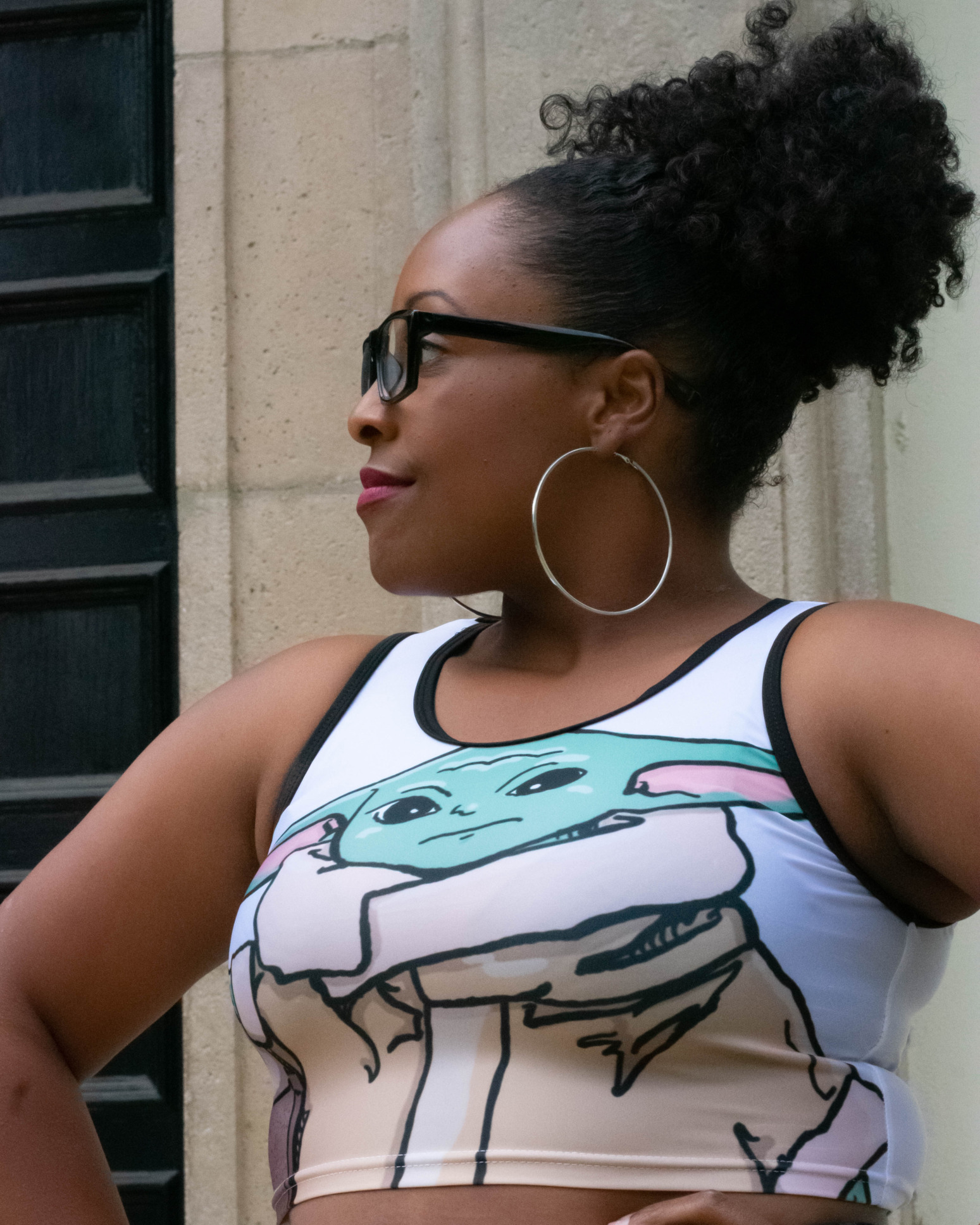 Closeup of a model wearing a very cute Baby Yoda crop top.