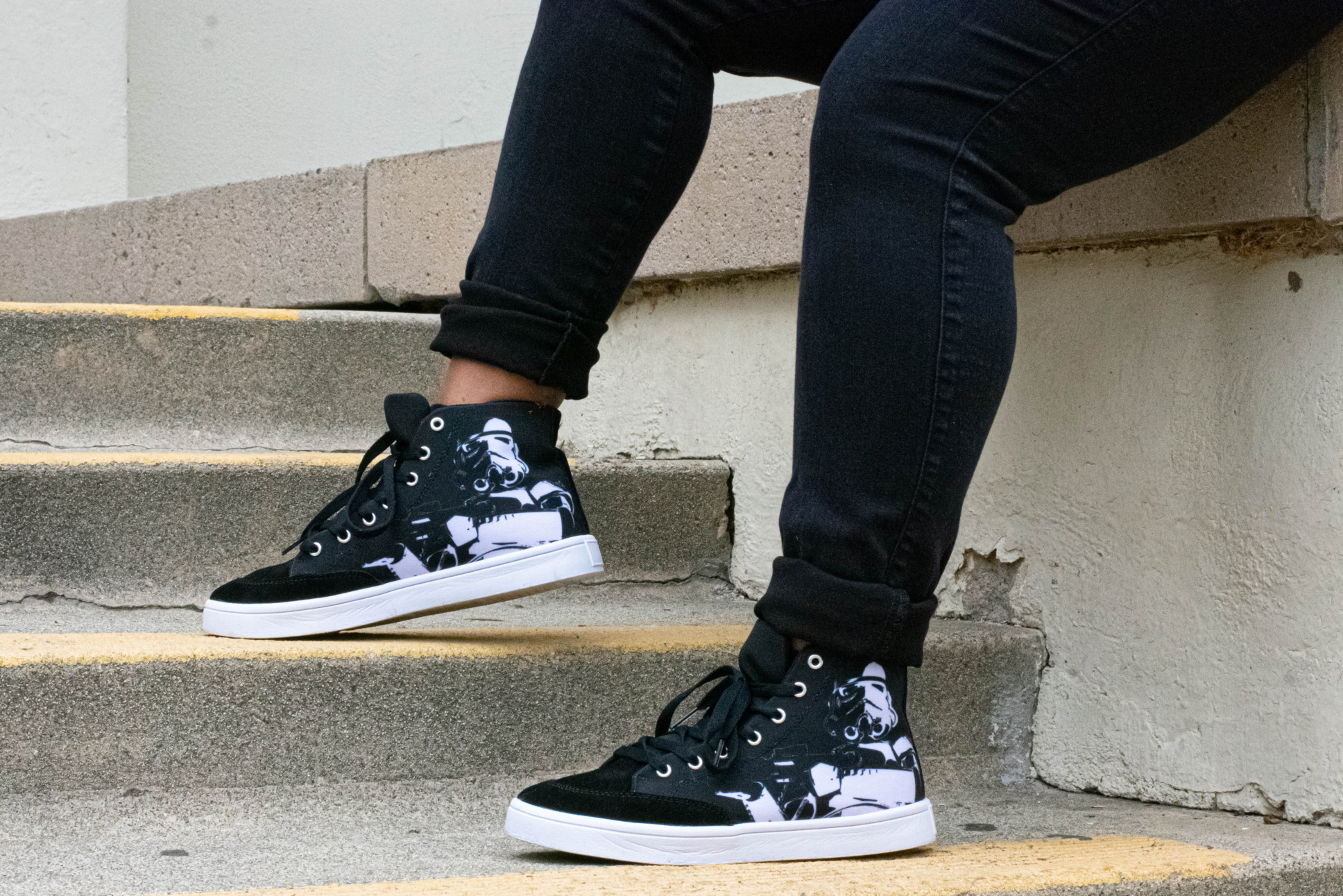 A closeup of high top sneakers with a Stormtrooper on them.